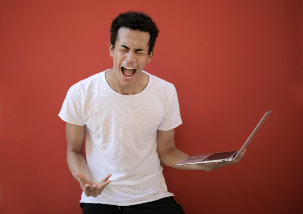 Photo by Andrea Piacquadio: https://www.pexels.com/photo/young-ethnic-male-with-laptop-screaming-3799830/